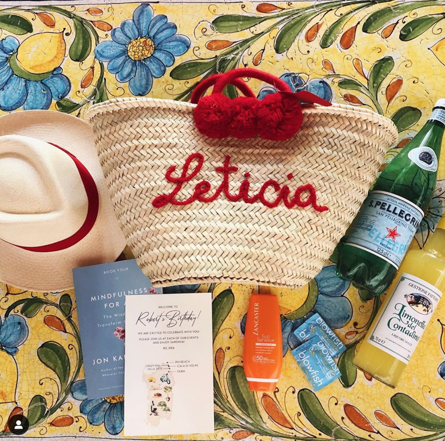 Custom-made tote bag with hat, sparkling beverages, and sun block.