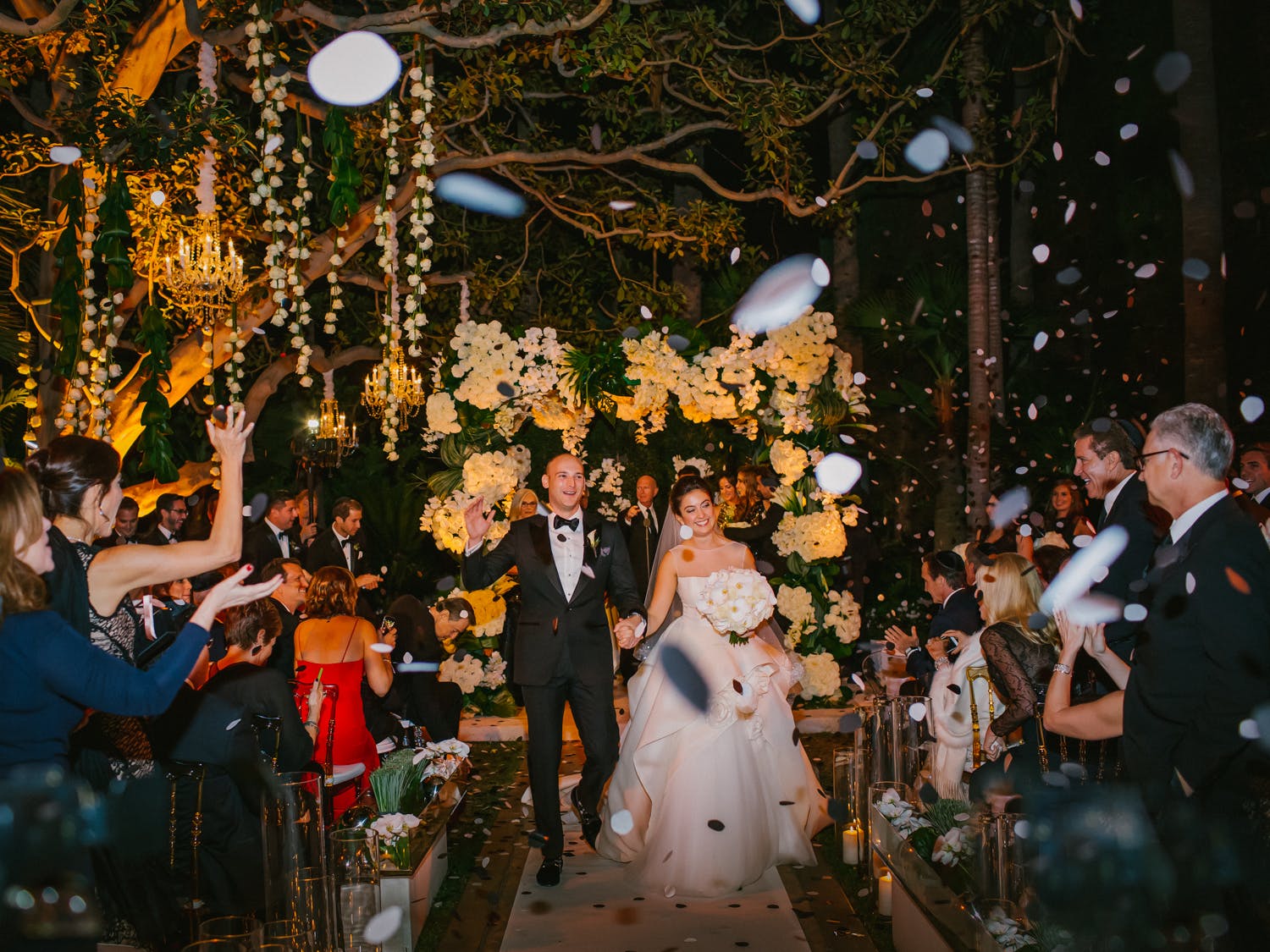 bride and groom exiting wedding during confetti toss