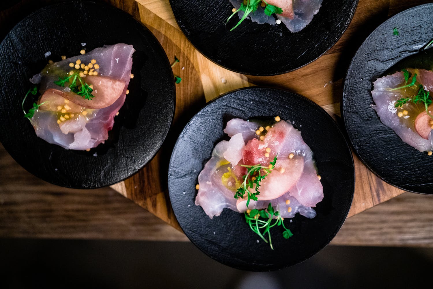 pink Poke fish served on black plates
