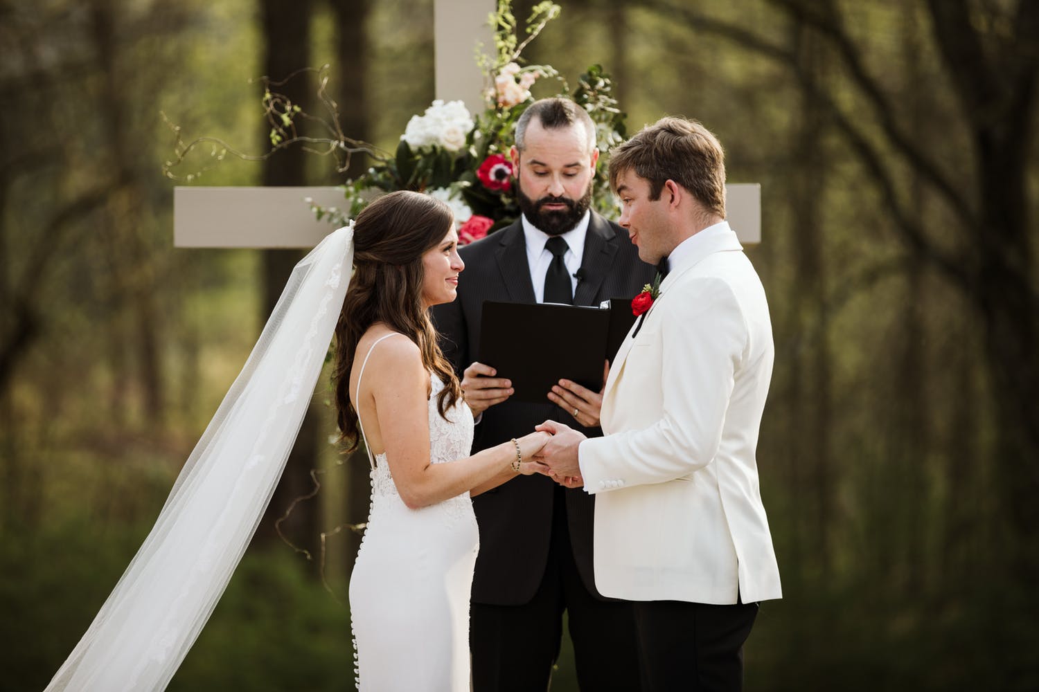 Bride and Groom exchanging vows in forest