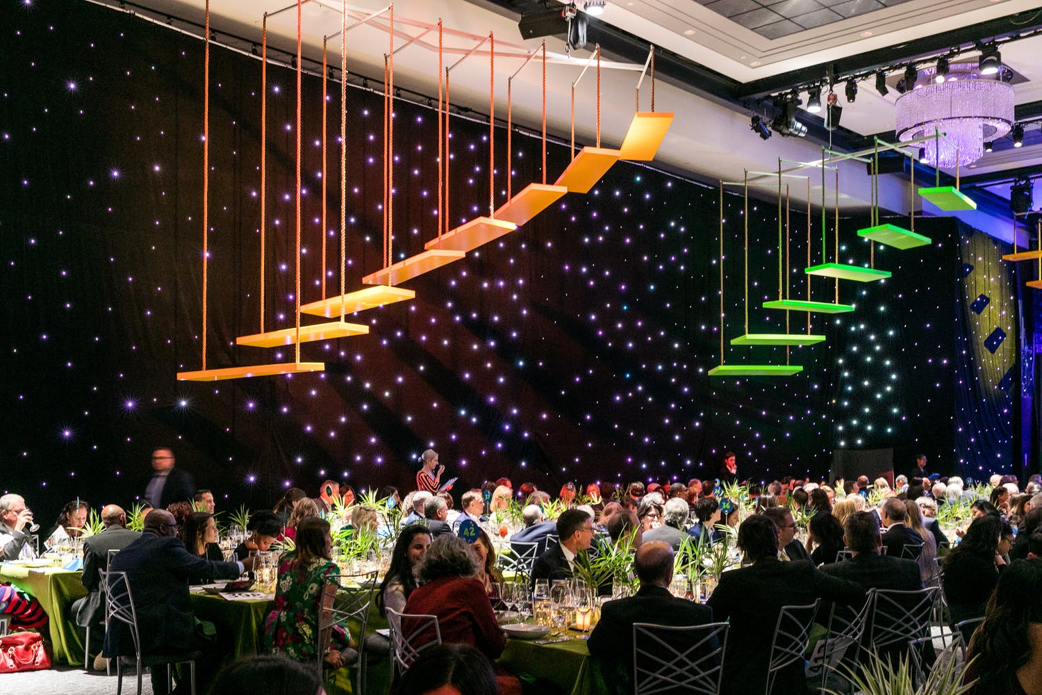 people dining beneath colorful 