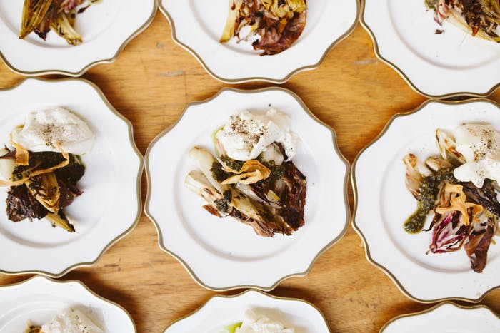 a photo of scallop-edged white plates with colorful foods.