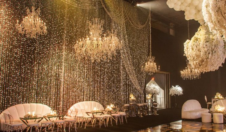 strings of lights cover wall at kardashian party