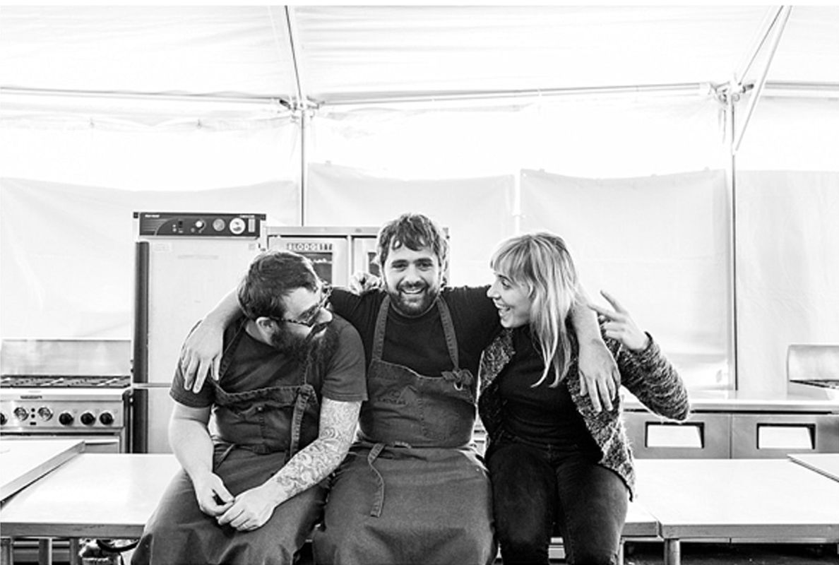 Three caterers take a break from the job to relax and pose for the camera.