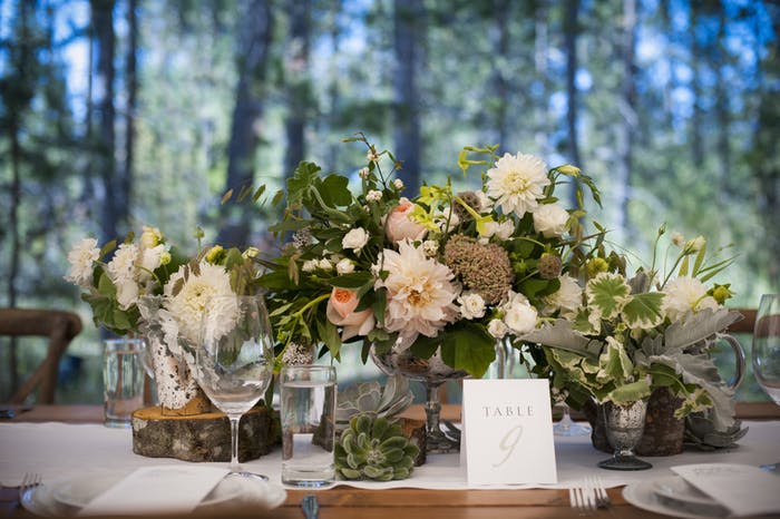 A short floral bouquet atop a table in the woods