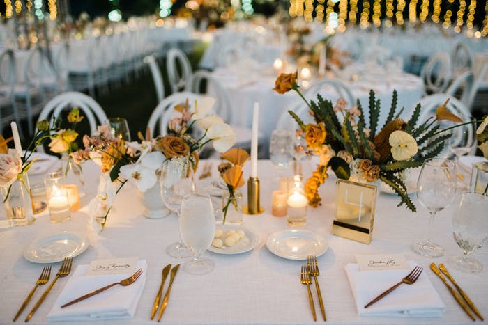 small pillar and votive candles with short succulent centerpieces