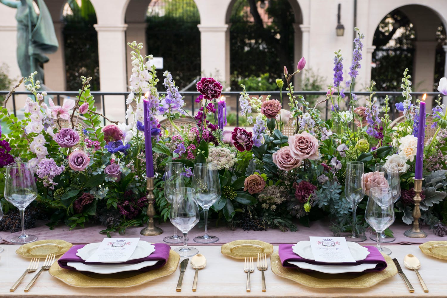 Purple candles with flowers of pink, purple and white.