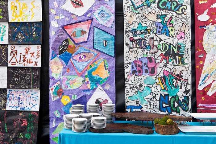 A wall space with different creative works of art on them