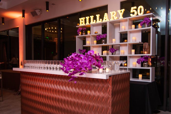 A Rose Gold Bar with Shelving in the Background and Pink Florals
