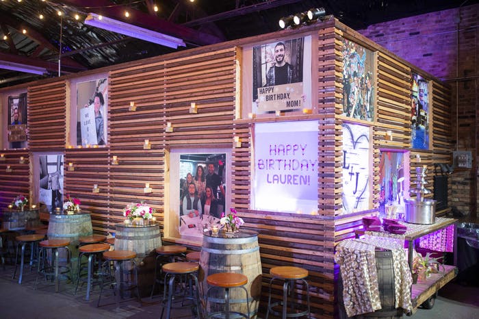 50th Birthday Celebration With Personalized Wall Art and Wine Barrel Tables | PartySlate