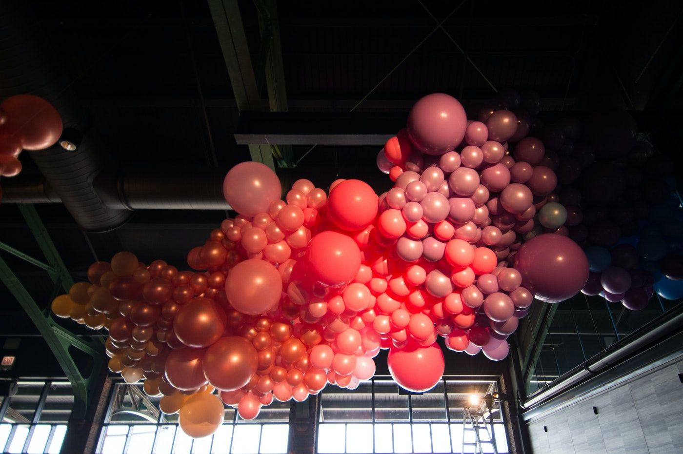 A display of balloons with various shades of pinks