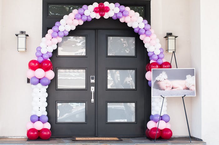 A black front foor with a purple, white and red balloon arch