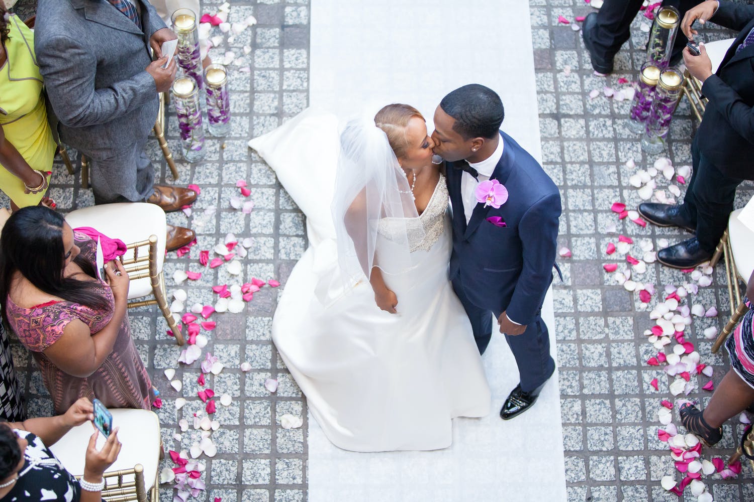Bride and groom stop to kiss in middle of the aisle at recessional.