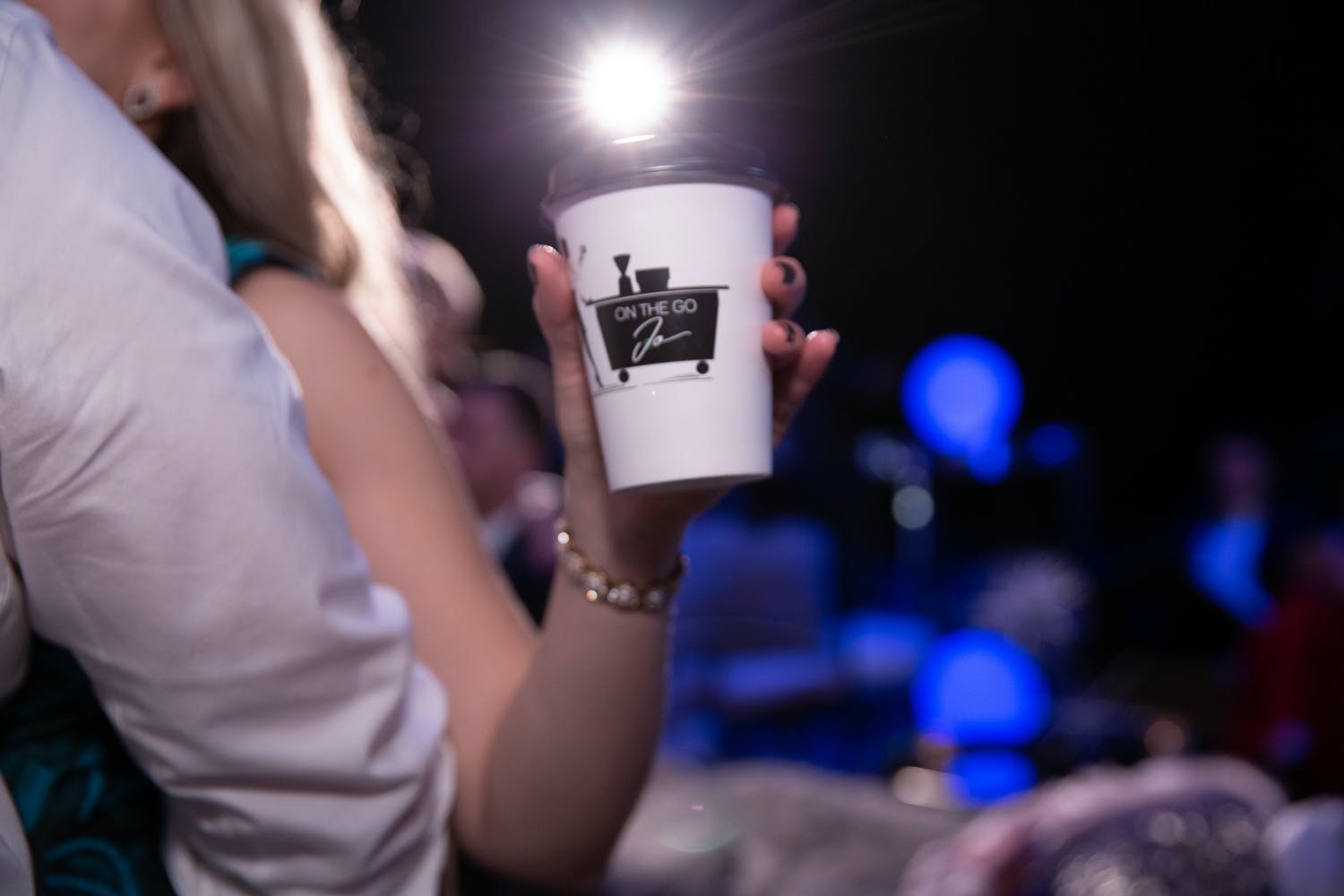 Hand holds cup of 