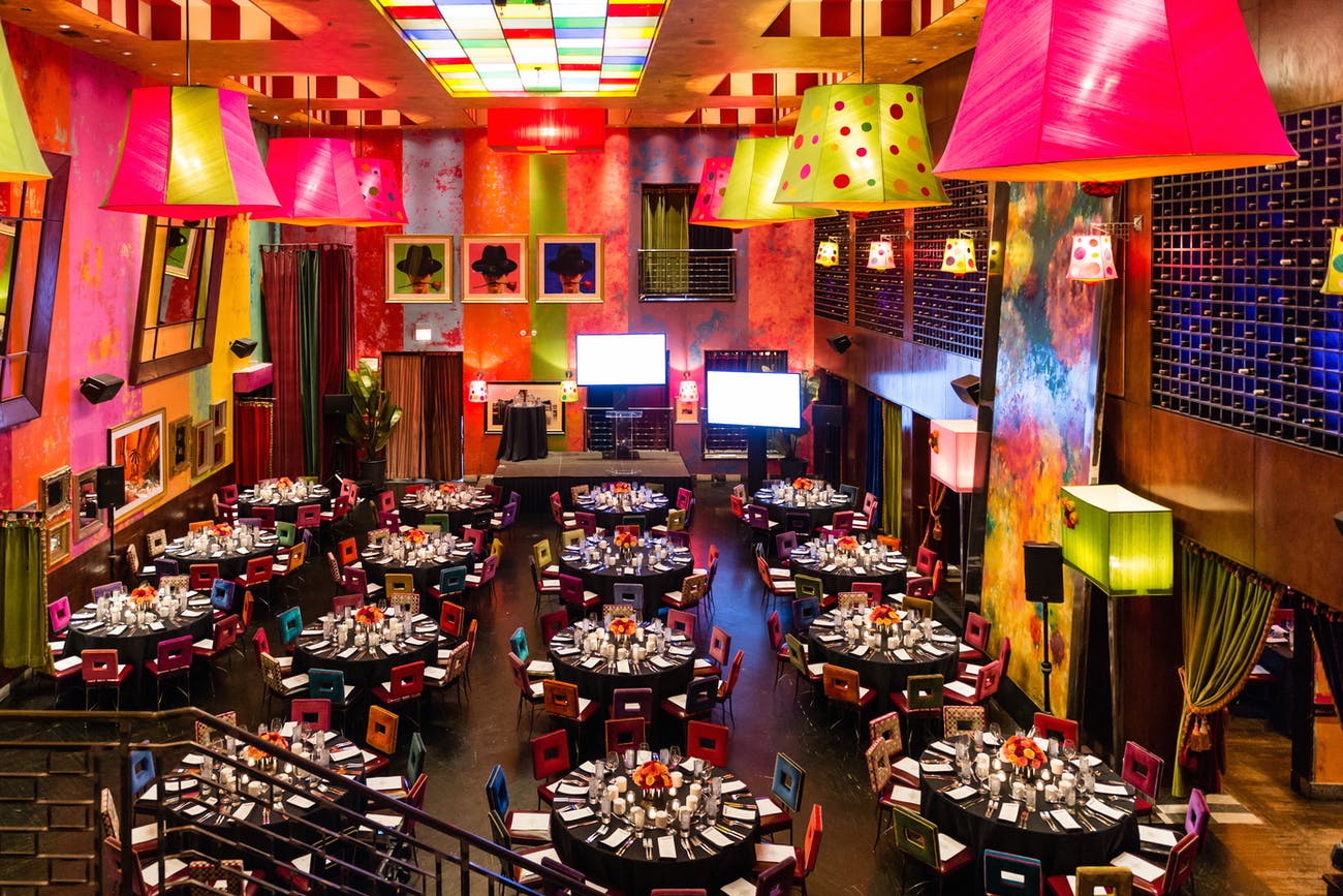 Colorful and bright main dining room with rows of round tables in Chicago | PartySlate