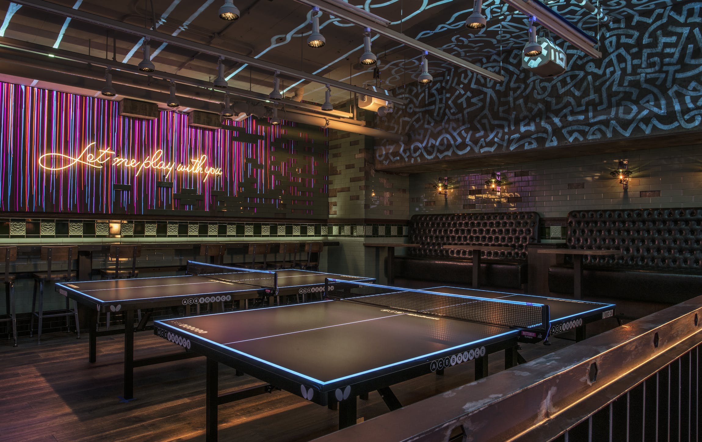 Private event space for your sweet sixteen with ping-pong tables, seating and abstract wall decor | PartySlate