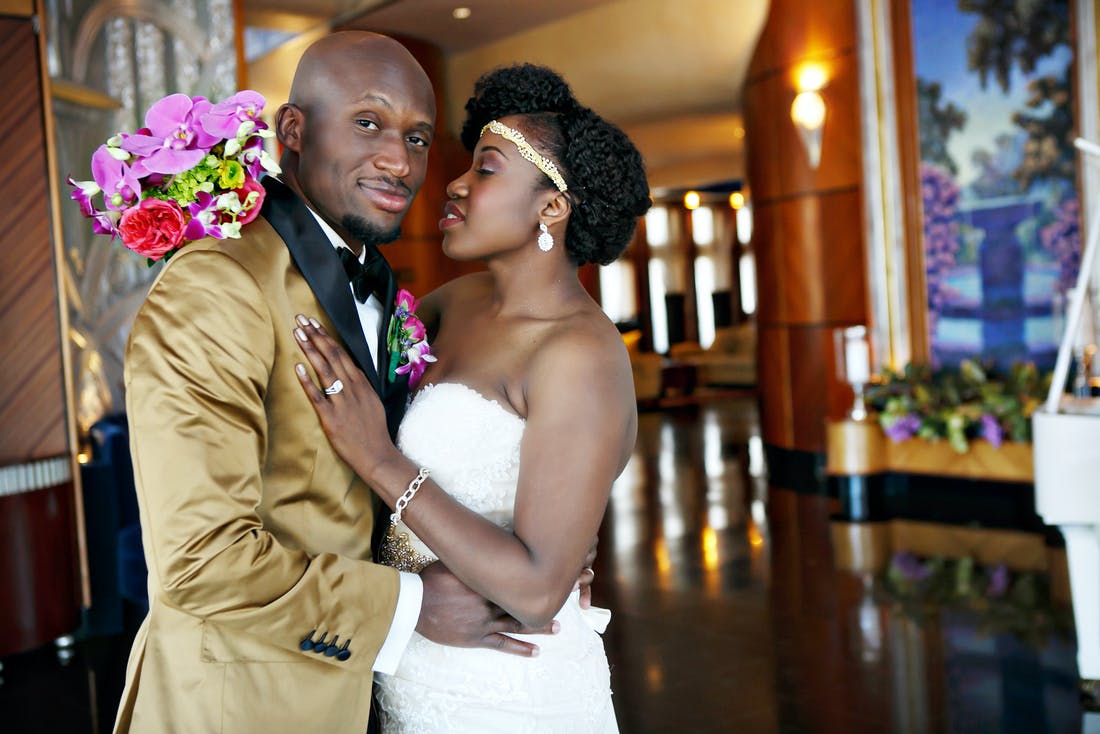 Bride and groom in white and gold | PartySlate
