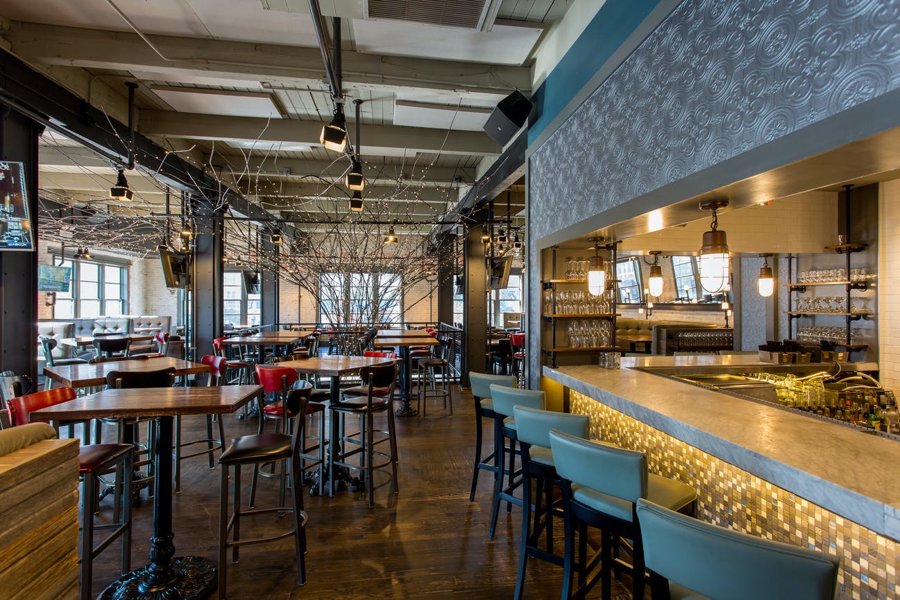 Upper level event space for your sweet sixteen in Chicago with a bar and high tables | PartySlate