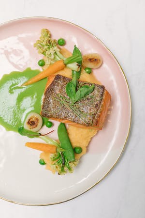 Pink ombre plate with food and sauces delicately placed | PartySlate