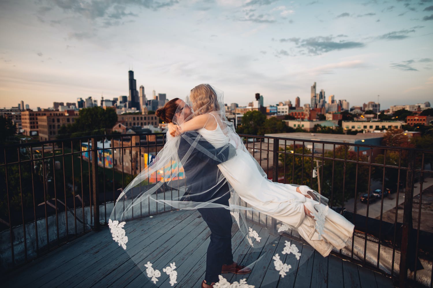 Bride and Groom Kiss Atop of Skydeck at Lacuna Events by LM Gallery | PartySlate