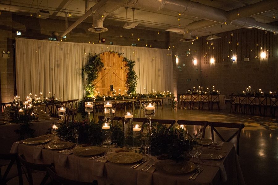 Romantic Candlelit Wedding Ceremony With Foliage at Ignite Glass Studio in West Loop Chicago | PartySlate