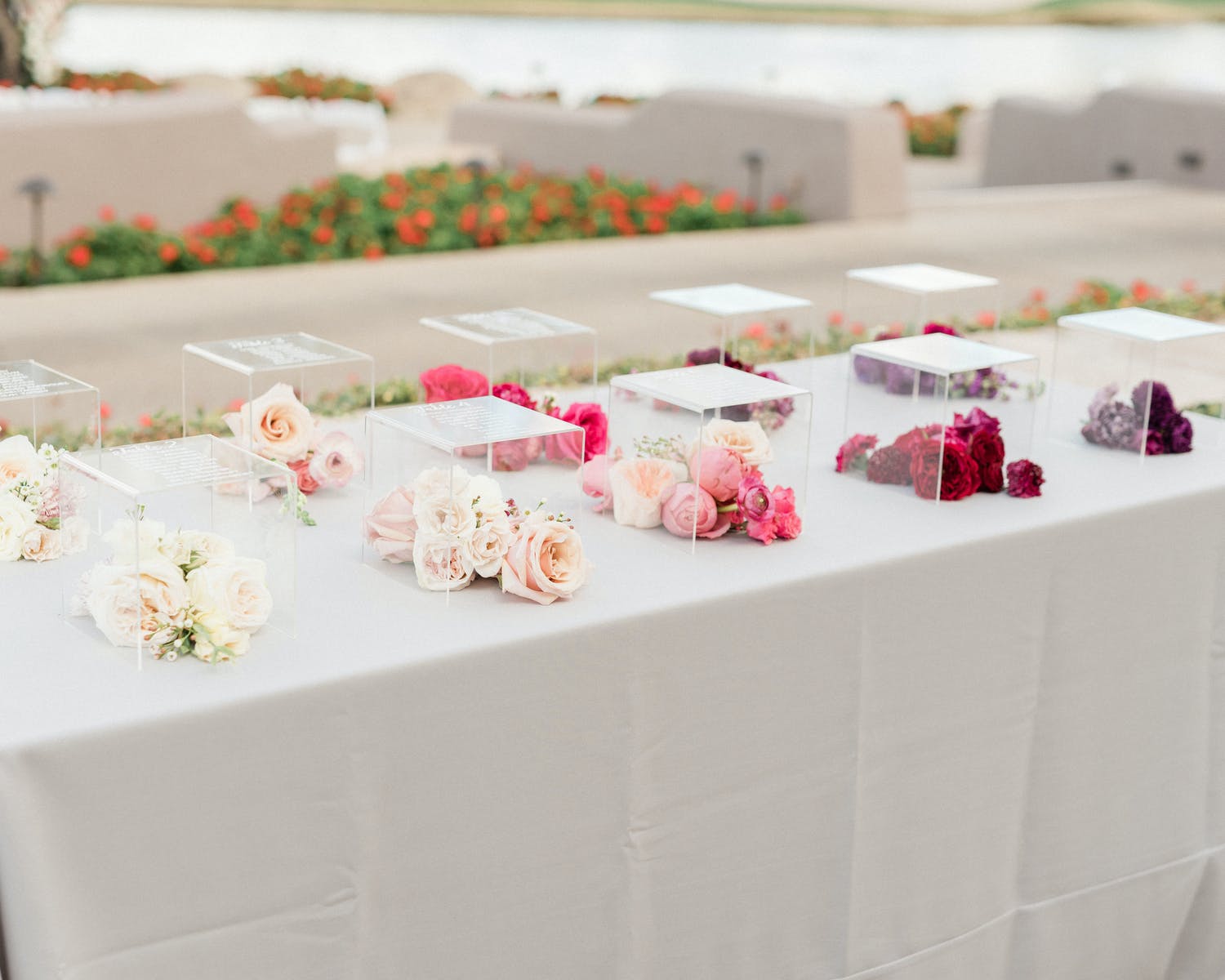 Lucite Boxes Inscribed With Wedding Table Numbers and Filled With Ombré-Hued Flowers | PartySlate