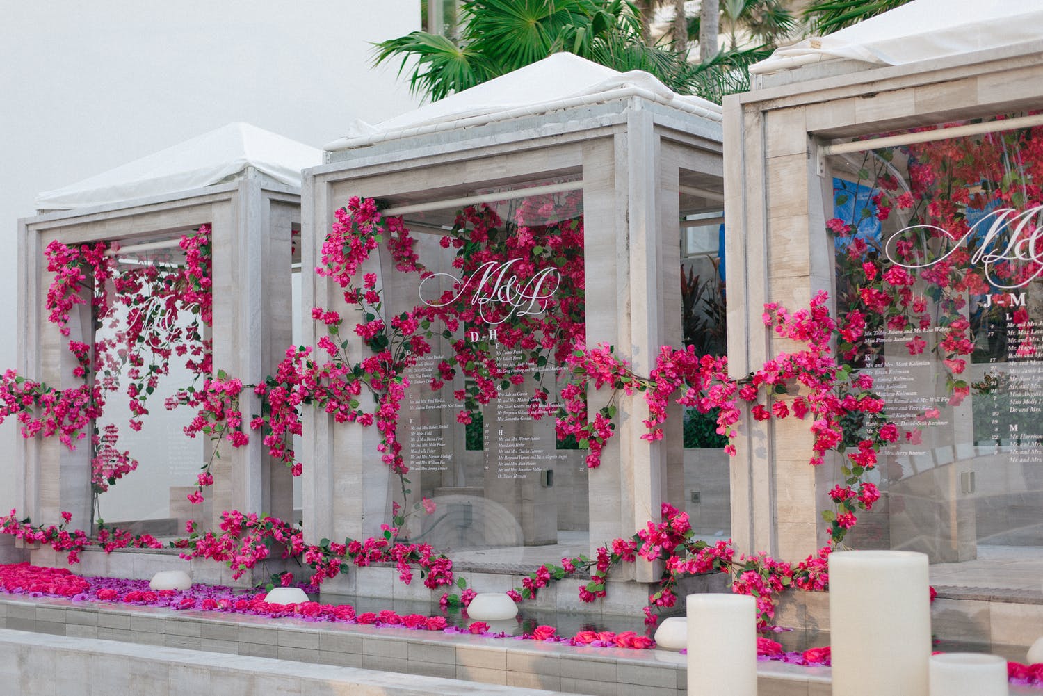 Three Acyrlic Wedding Seating Charts Covered in Pink Flowers at The Ritz-Carlton Bal Harbour | PartySlate