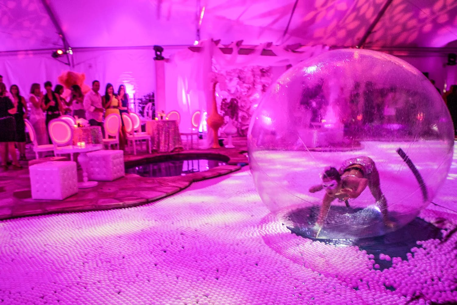 Dancer Performs in Bubble on Ping Pong-Filled Party Pool With Pink Uplighting | PartySlate