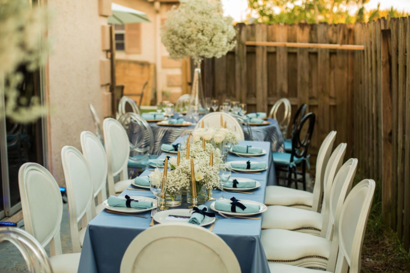 Tablescape With Light Blue Linen, White Modern Seating, and Baby's Breath Centerpieces | PartySlate