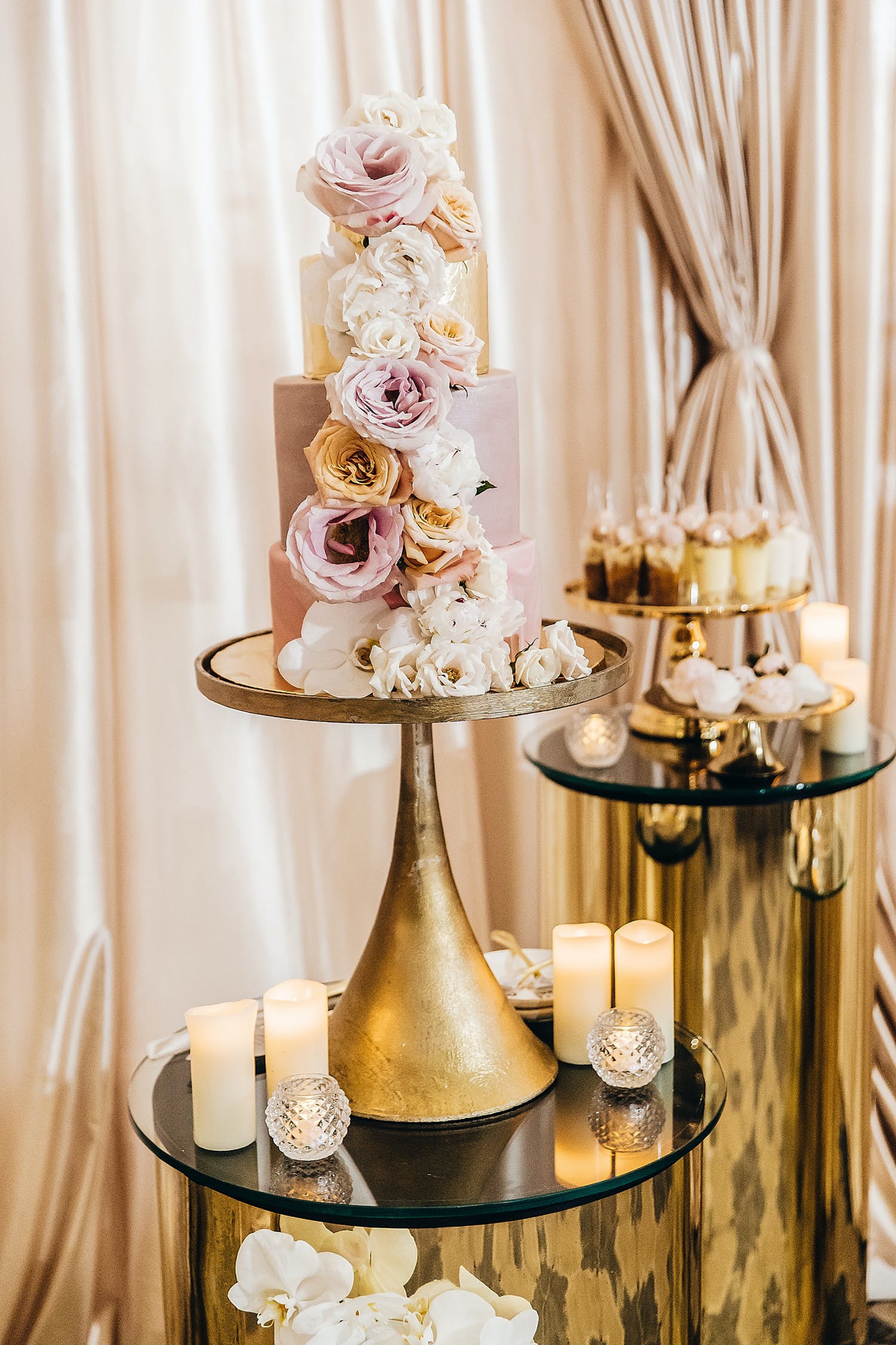 Luxe and Romantic Pink Wedding Cake With Cascade of Flowers Down Side | PartySlate