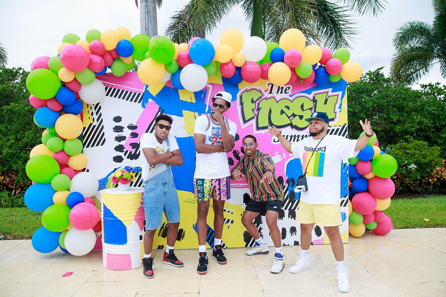 Friends Pose in Front of Fresh Prince of Bel-Air Balloon Backdrop for Birthday Party | PartySlate