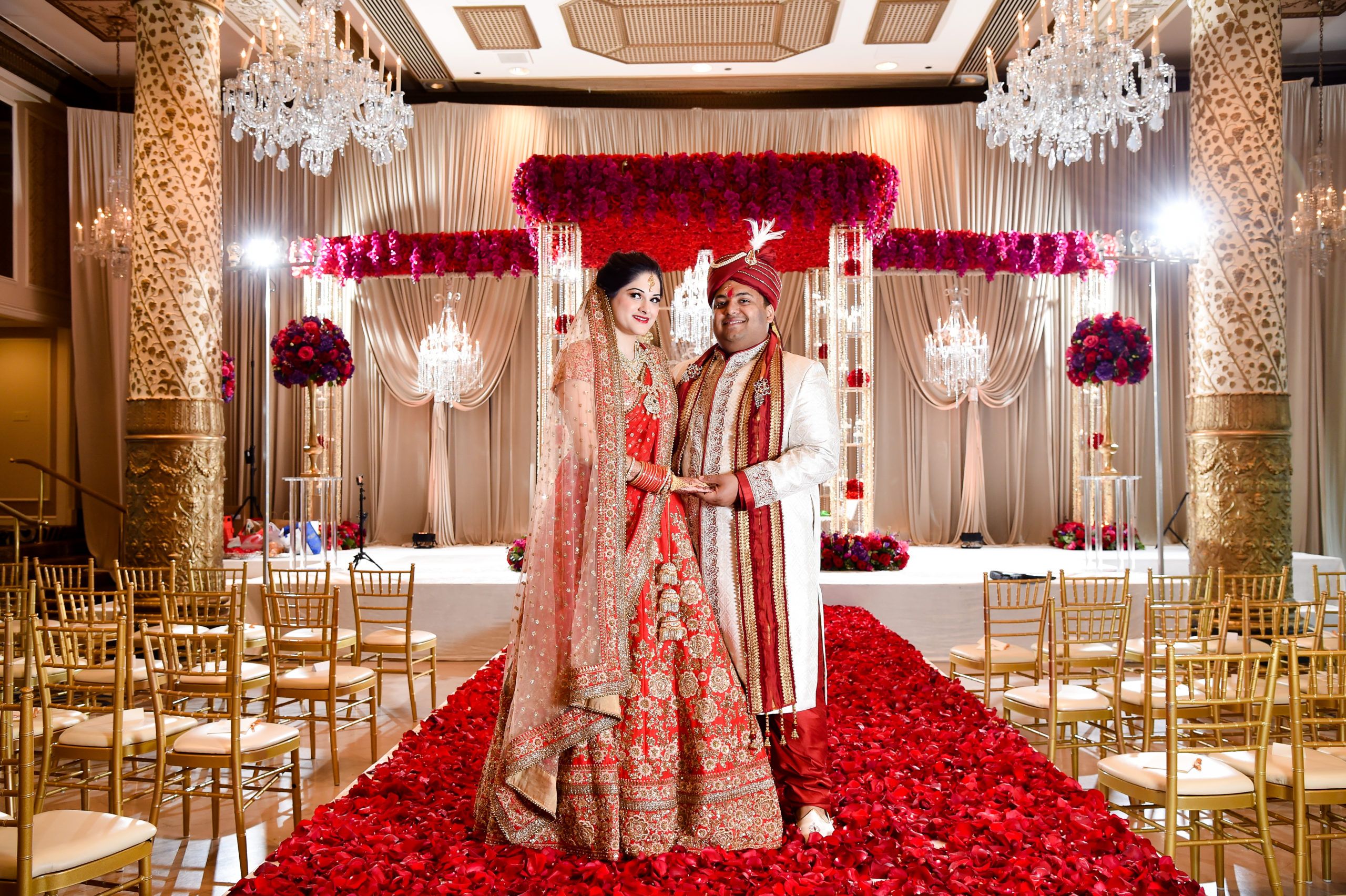 Bride and Groom Stand in Front of Rose-Covered Mandap at South Asian Wedding at Hilton Chicago | PartySlate