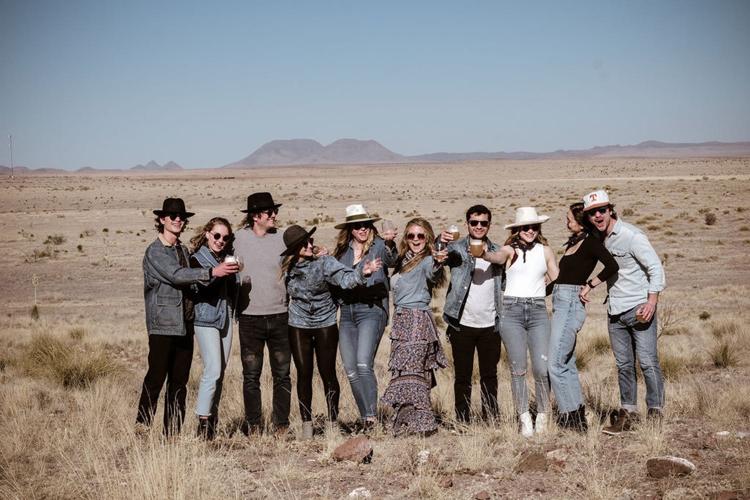 Group of Friends Pose for a Photo Against a Desert Backdrop for a Small Birthday Party | PartySlate