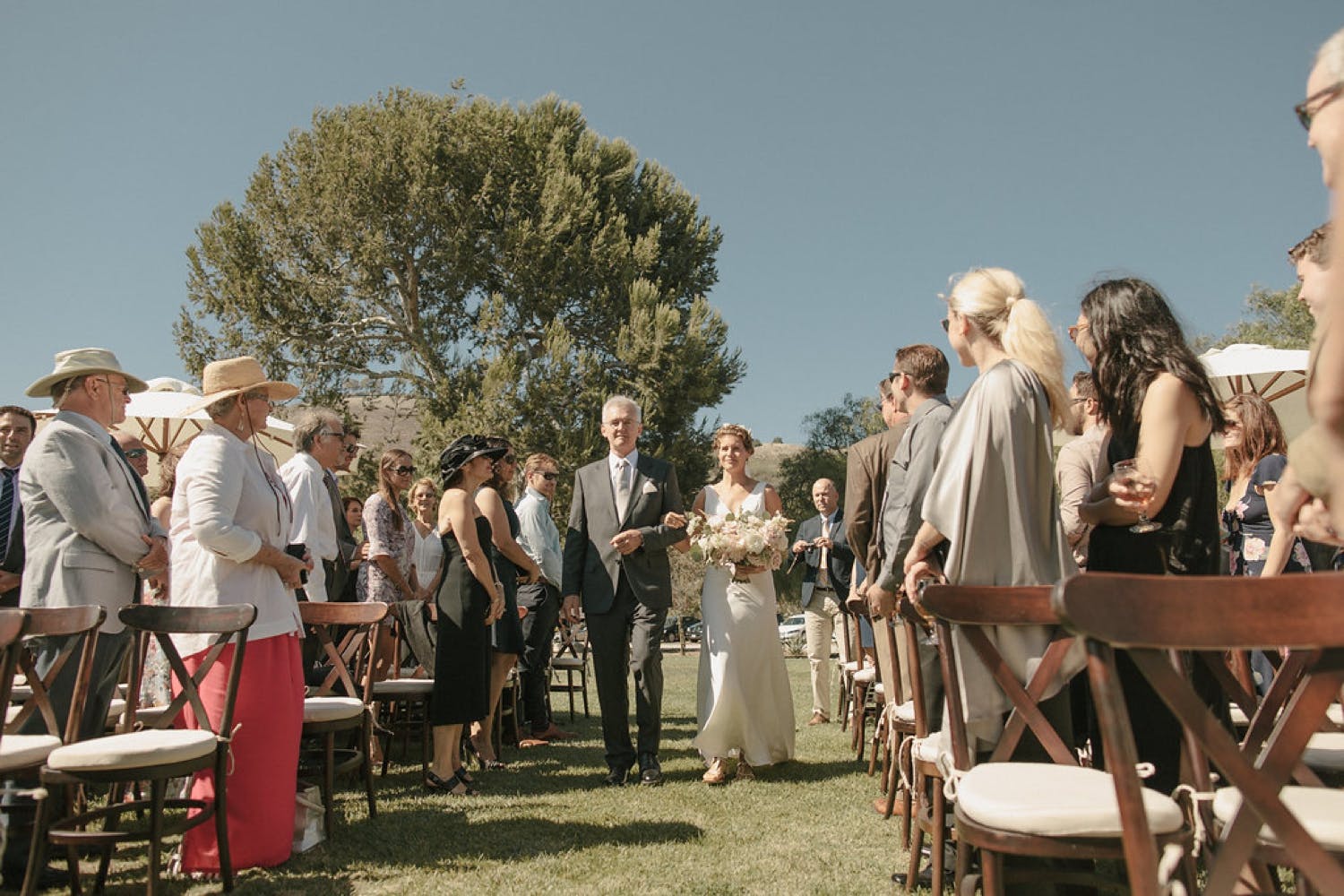 Bride and Groom Recessional Down the Aisle Outdoors at Catalina View Gardens in Rancho Palos Verdes, CA | PartySlate
