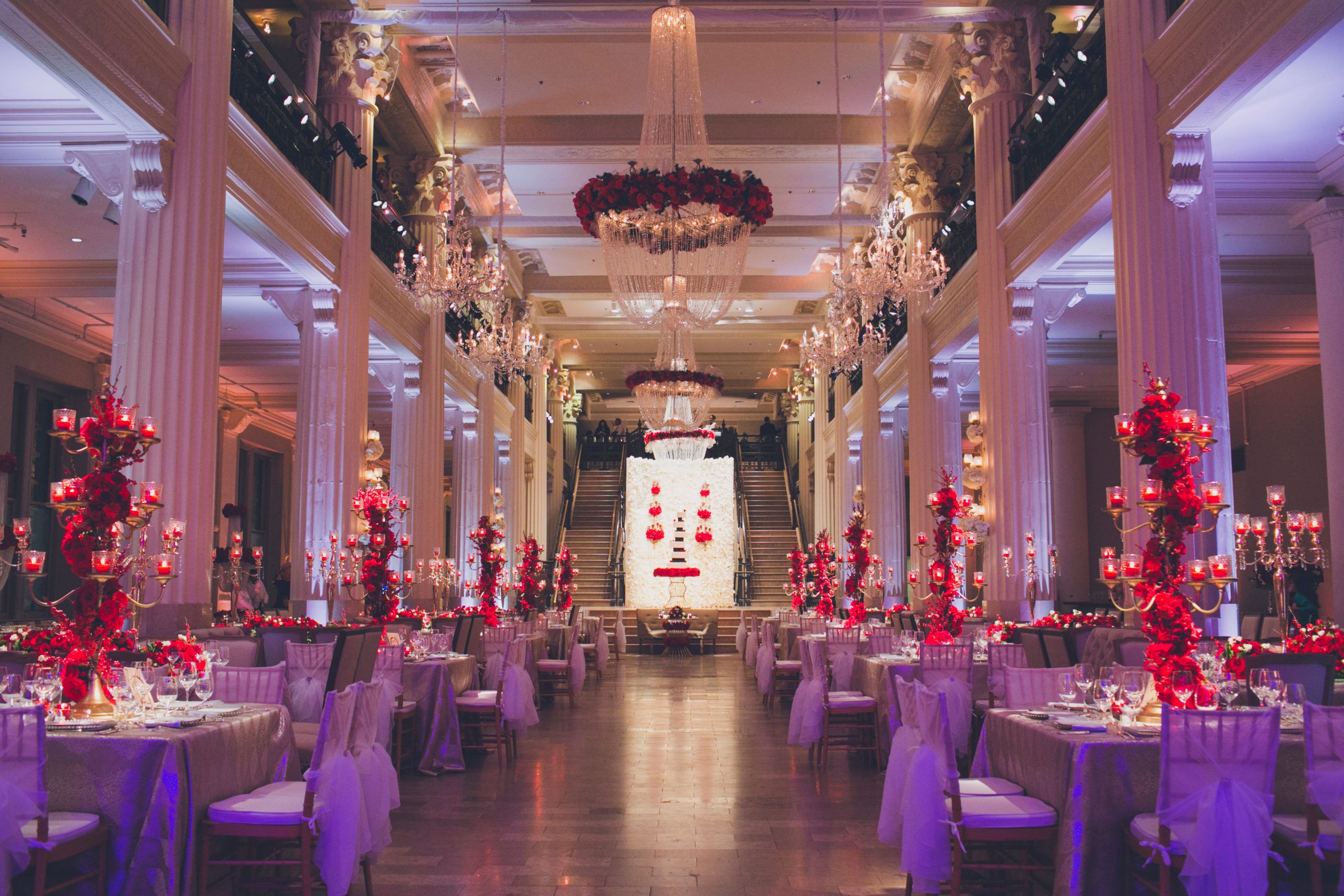 Glamorous Ballroom Celebration with Red Floral Décor and Glittery Chandeliers Planned by Elite Eventz of Houston, TX | PartySlate