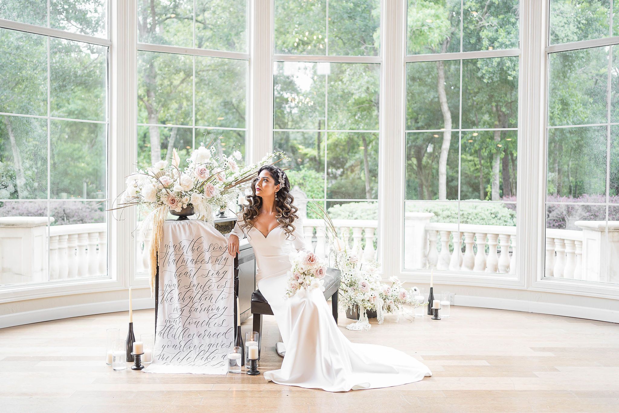 Bride with white and blush boho-style floral décor designed by EVENT by OVA | PartySlate
