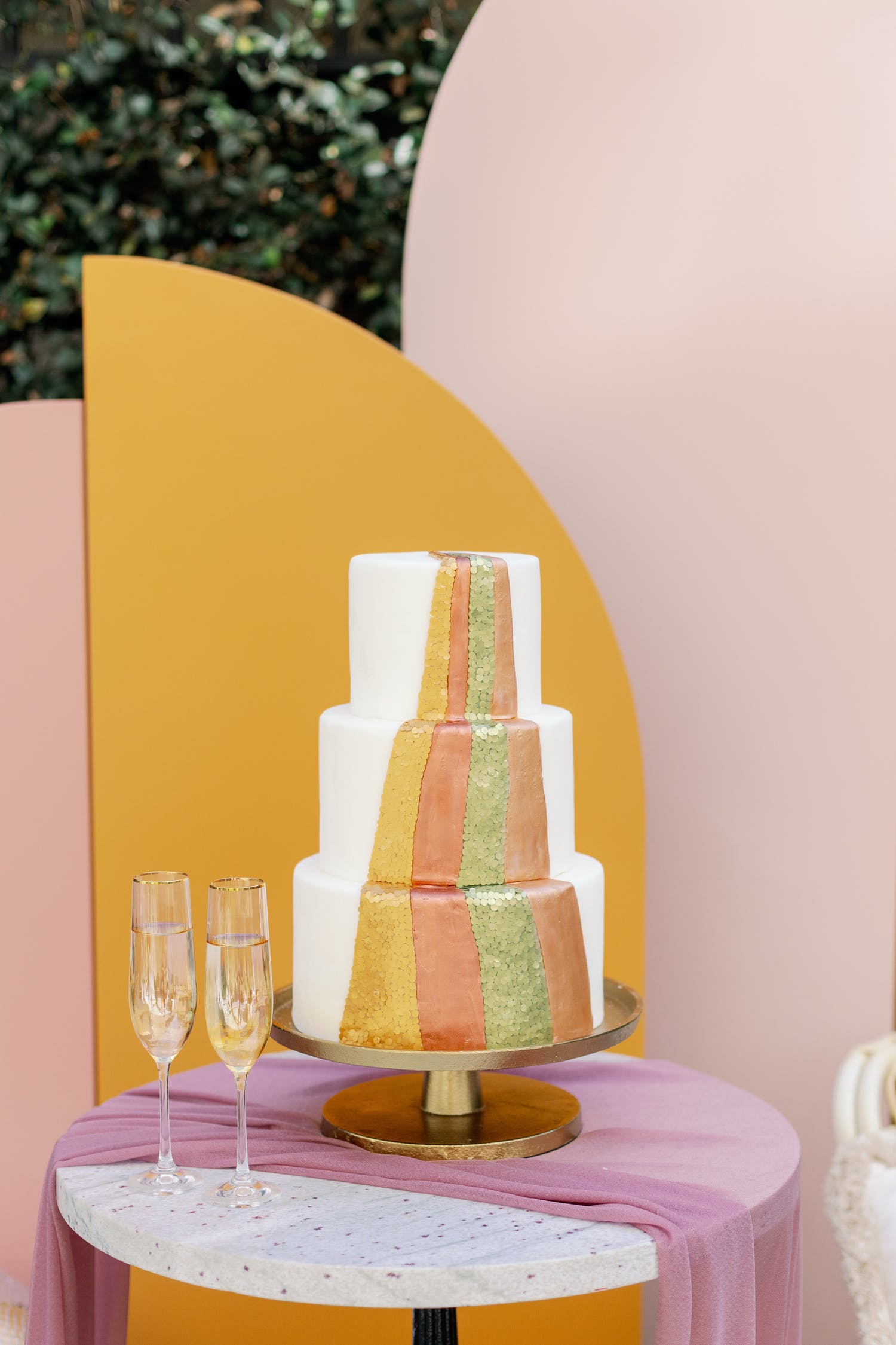Three tier boho, 70s style wedding cake with multiple bright colors | PartySlate