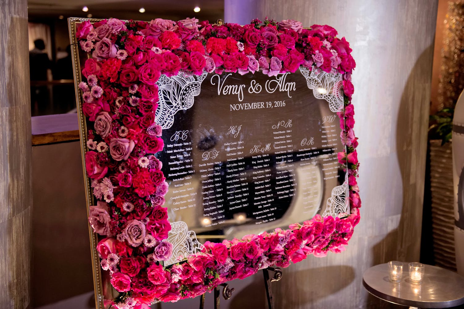 Mirrored Seating Chart Framed in Bright Pink Flowers Designed by Keisha's Kreations of Houston, TX | PartySlate