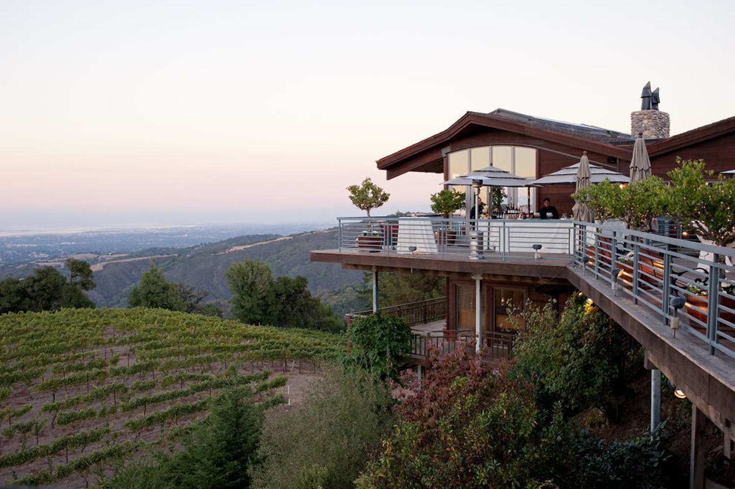 Terrace of a darkwood building at Thomas Fogarty Winery overlooking vineyards and the Santa Cruz Mountains | PartySlate