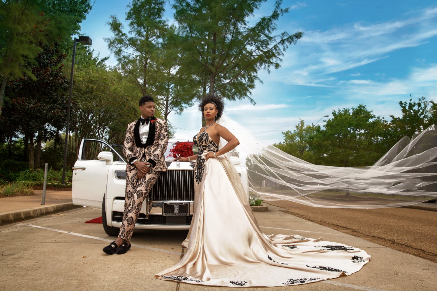 Bride and Groom in Unique Clothing Pose in Front of Vintage White Car at Wedding Planned by Wise Events & Design of Houston, TX | PartySlate