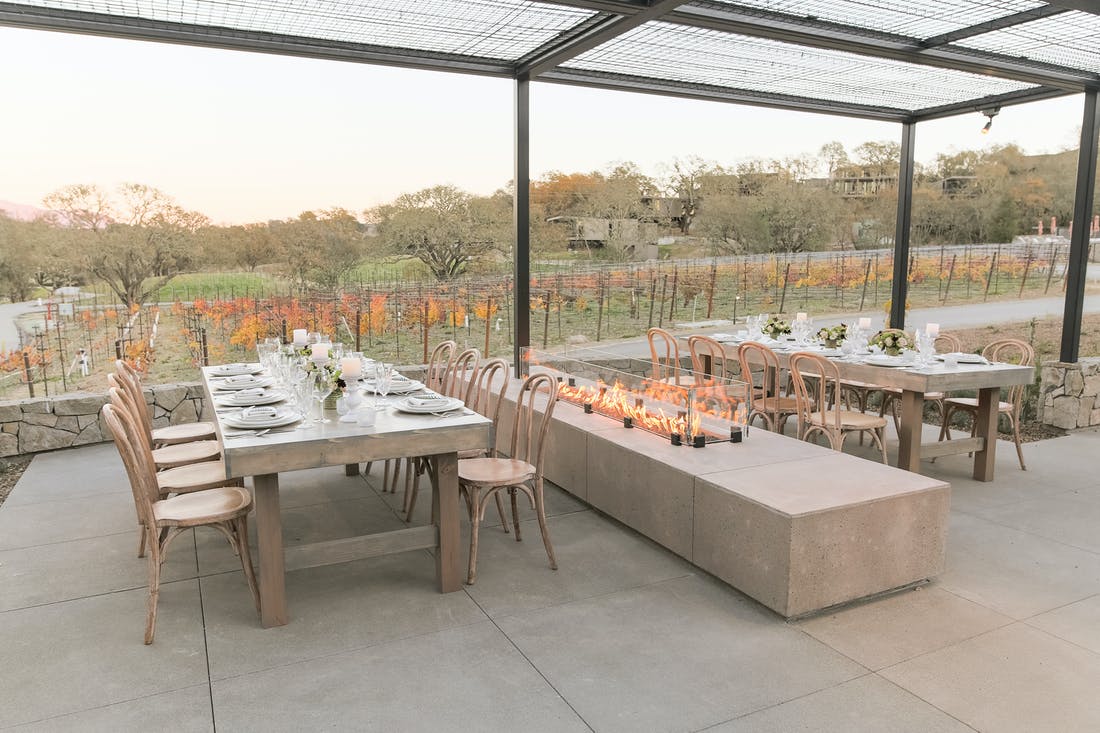 Tables Next To a Glass Fireplace Looking At Vineyards | PartySlate