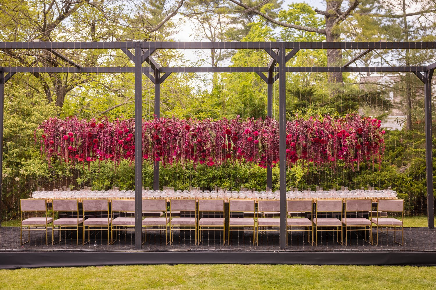 Outdoor wedding tablescape with elevated bright pink floral centerpieces | PartySlate