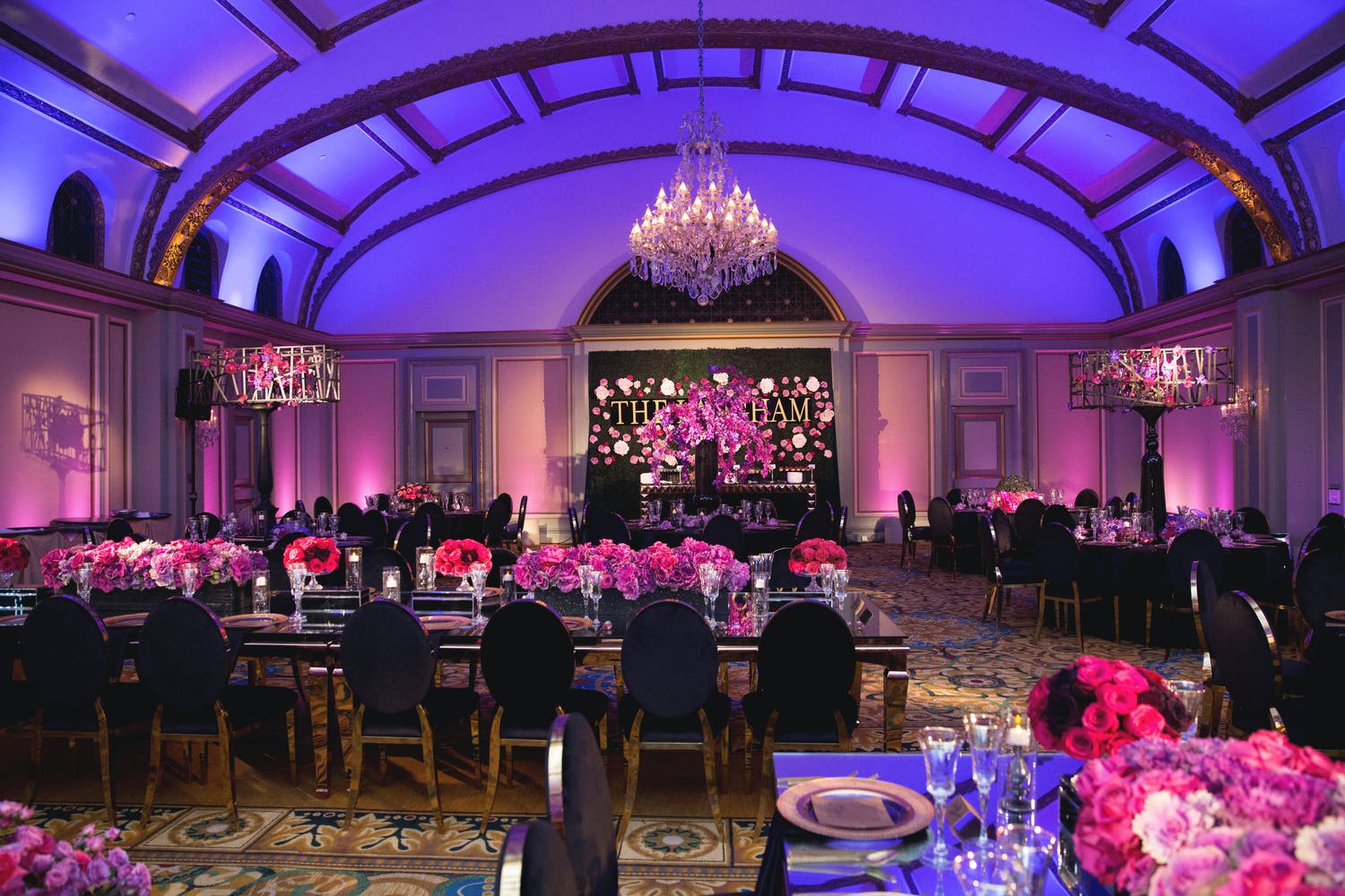 Corporate event at Viennese Ballroom at The Langham Huntington Hotel with purple uplighting and bright pink floral décor | PartySlate