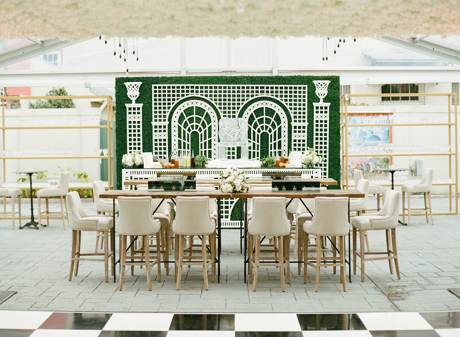 Tented wedding with boxwood backdrop with white garden design | PartySlate