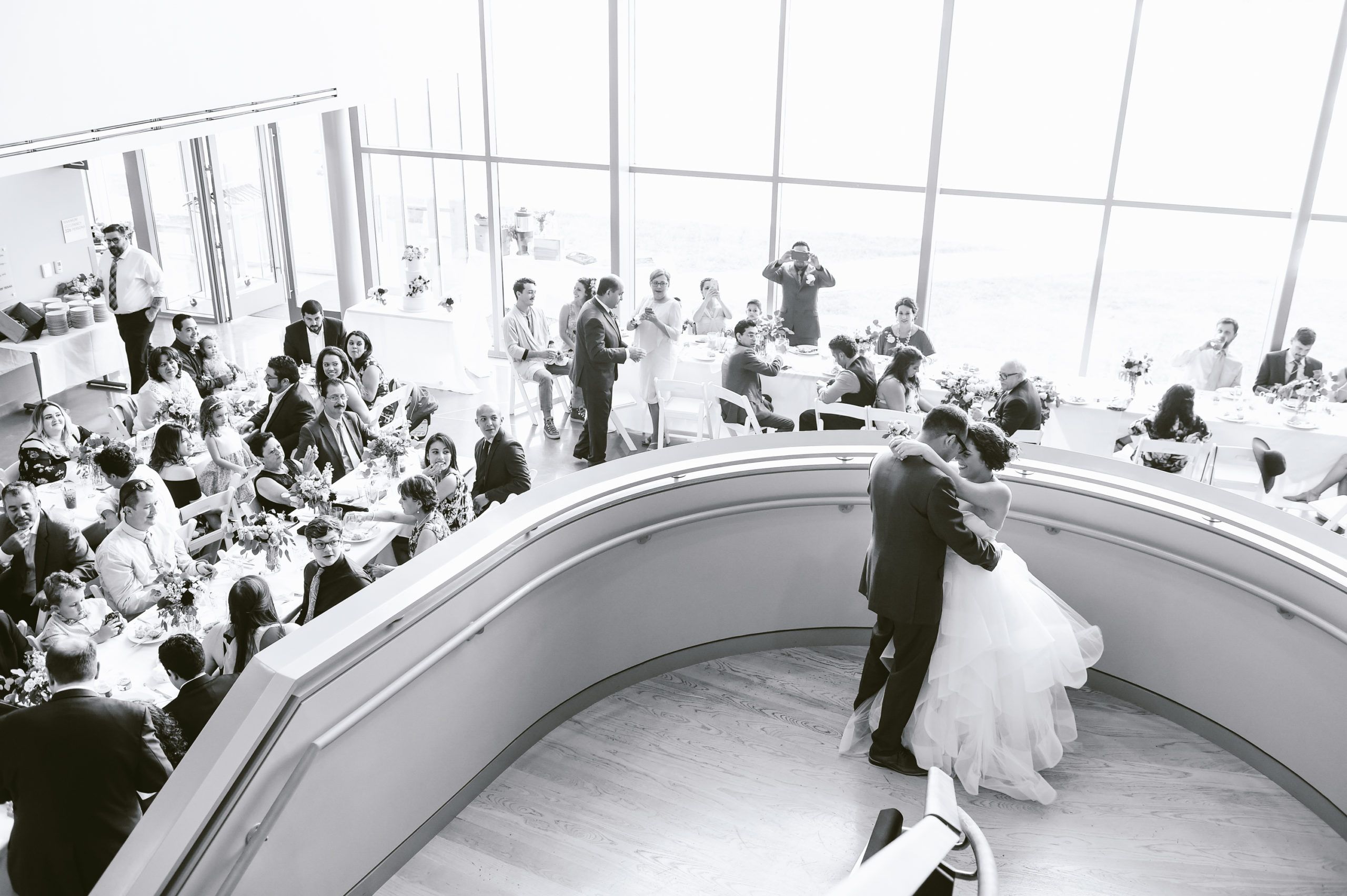 Black and White Photo of Couple at Botanic Gardens in Fort Worth Standing on Atrium Stairs | PartySlate