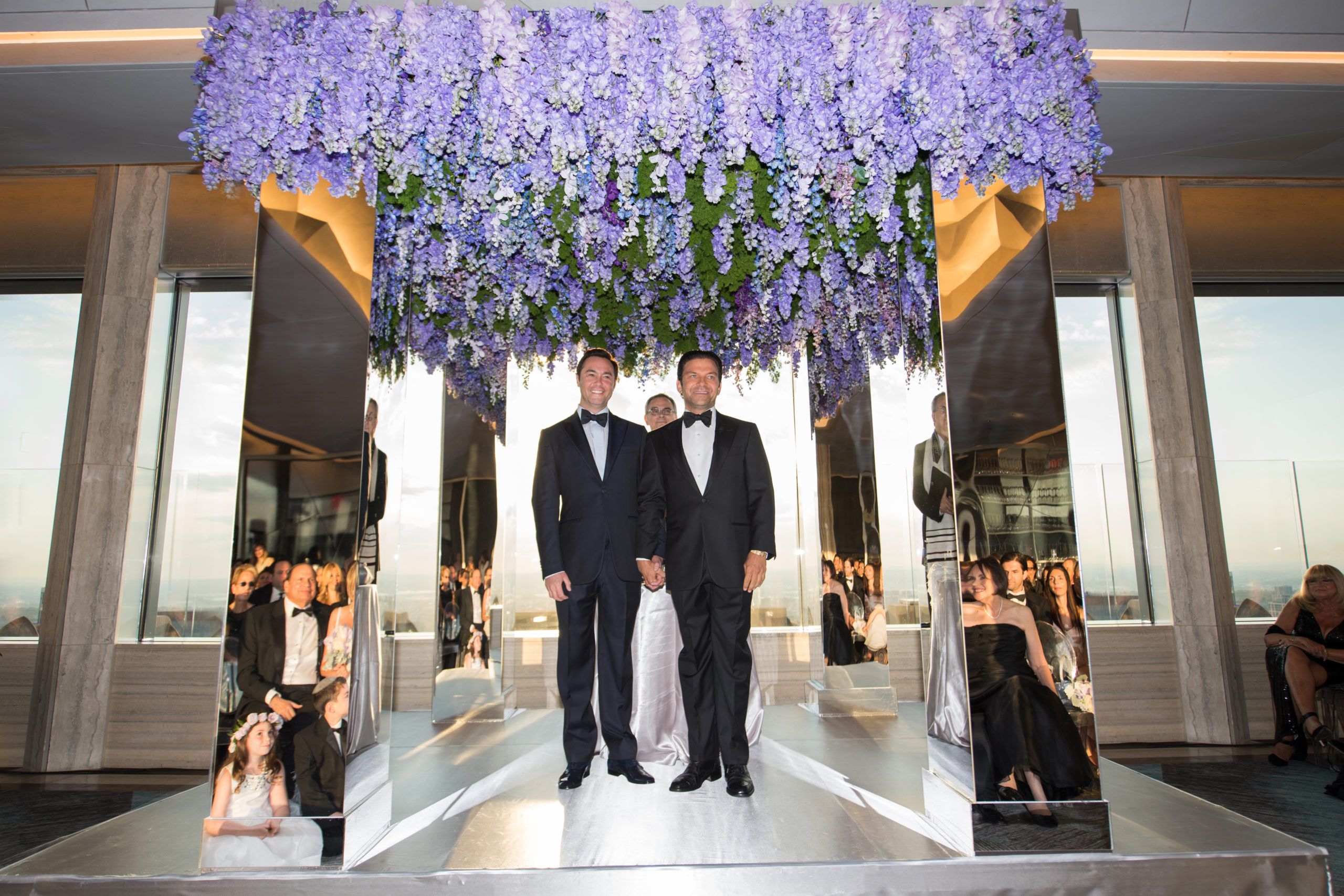 Two grooms at the alter on their wedding day