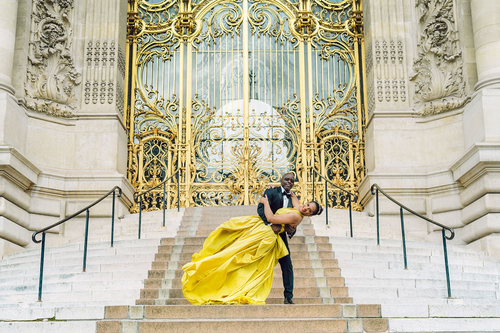 Groom dips bride in yellow ball gown at event planned by PiEvents & Co | PartySlate