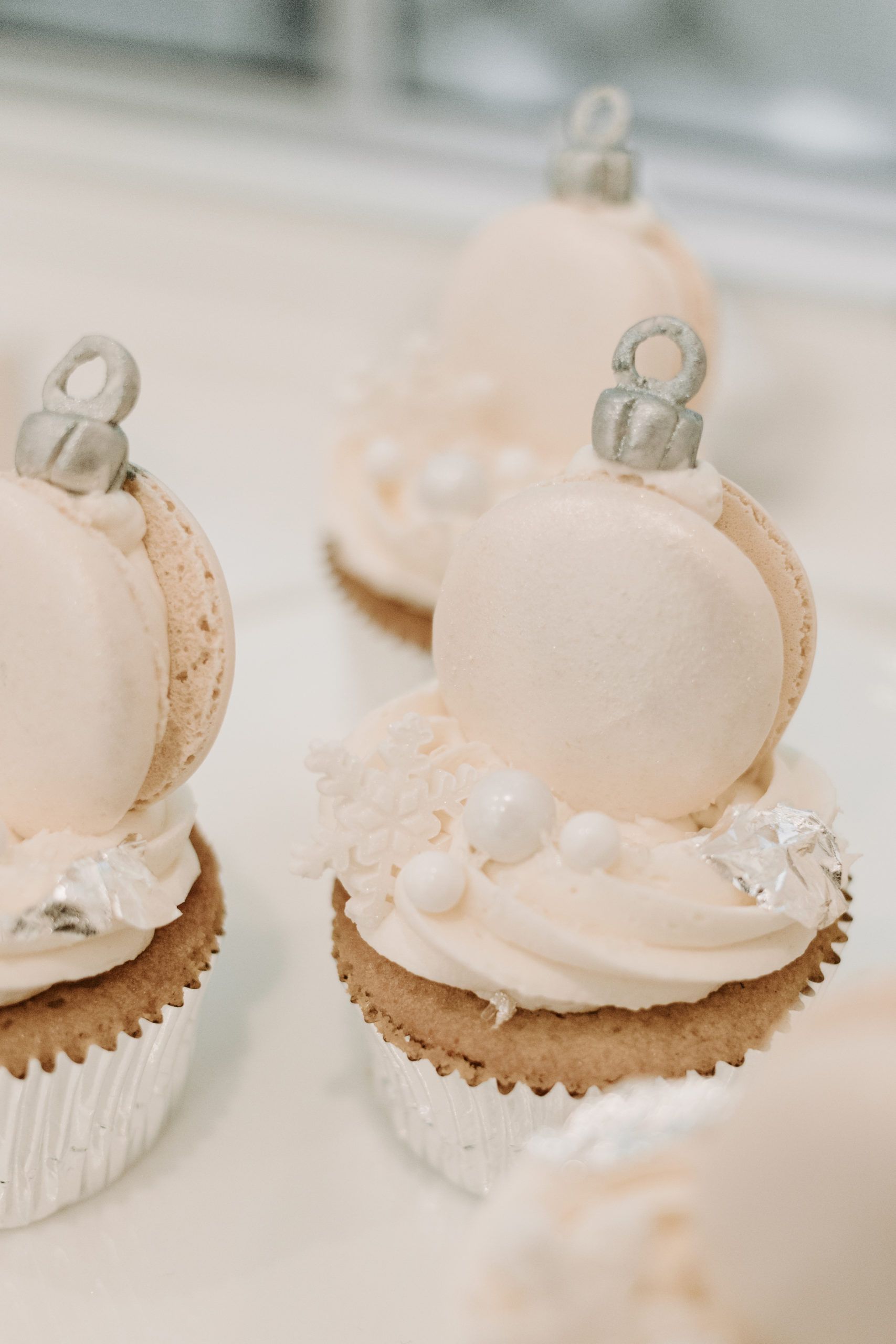 White donuts with snowflake candy and ornament designed cupcakes | PartySlate