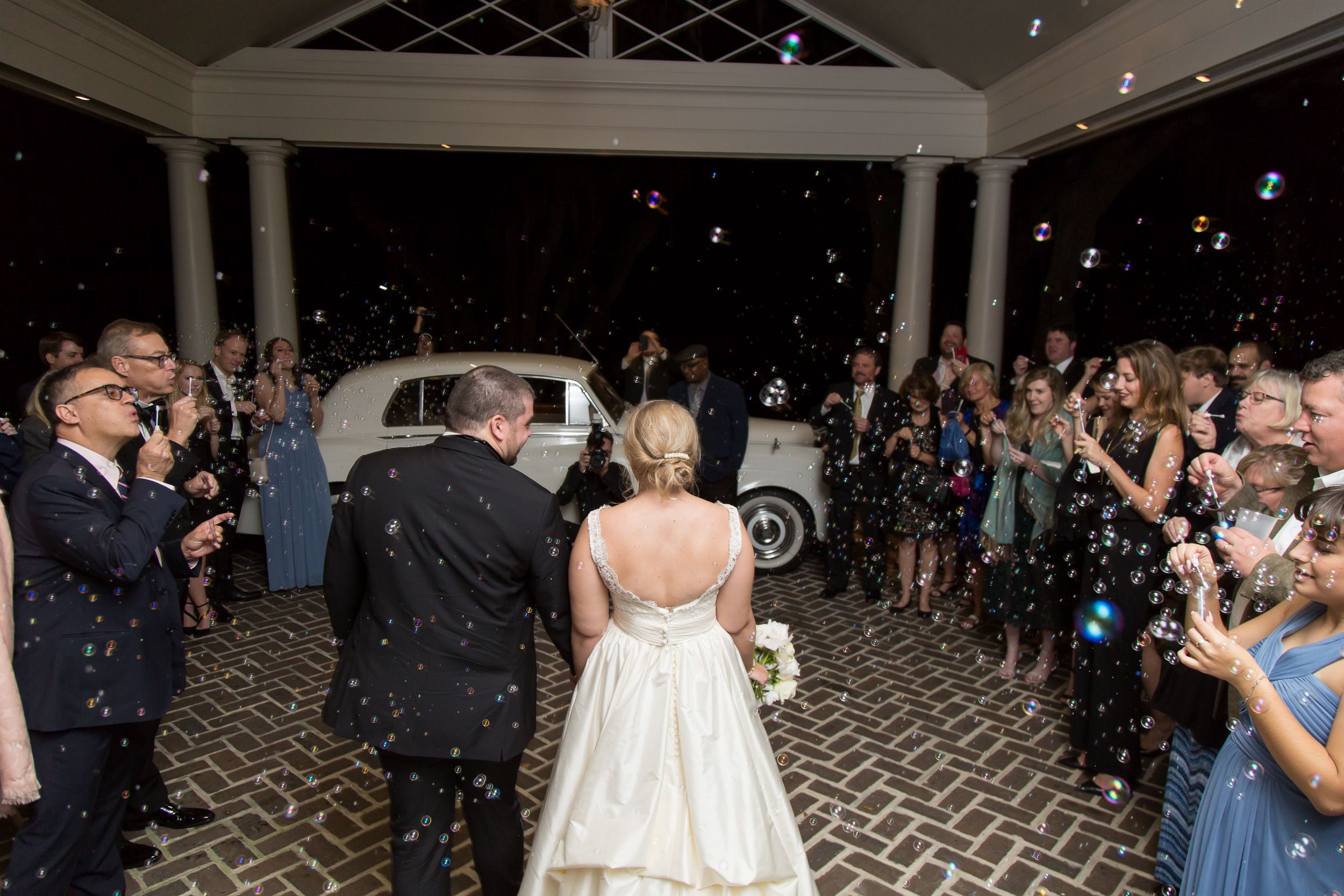 Creative Wedding Exit With Bubbles As Couple Leaves Wedding Venue At Night | PartySlate