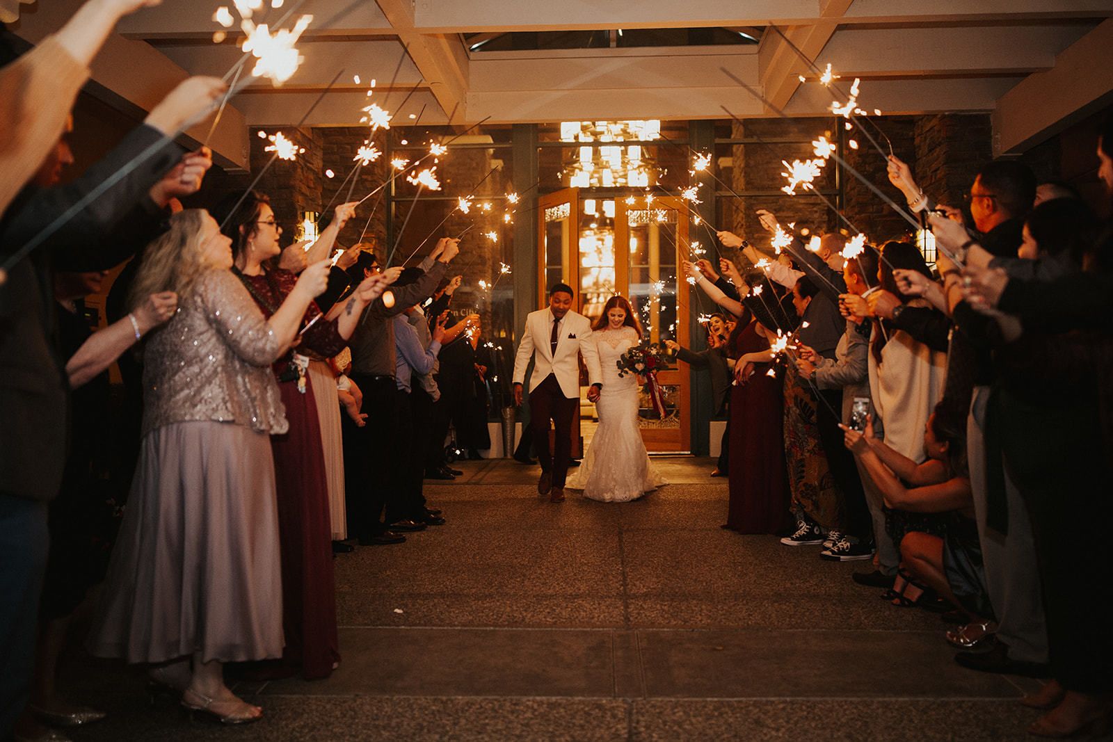Outdoor Wedding at the Timber Creek Ballroom in Roseville, CA Couple Wedding Exit with Sparklers | PartySlate